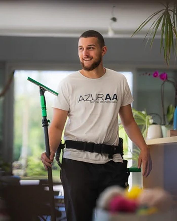 Léo, technicien Azuraa, raclette télescopique à la main dans une véranda